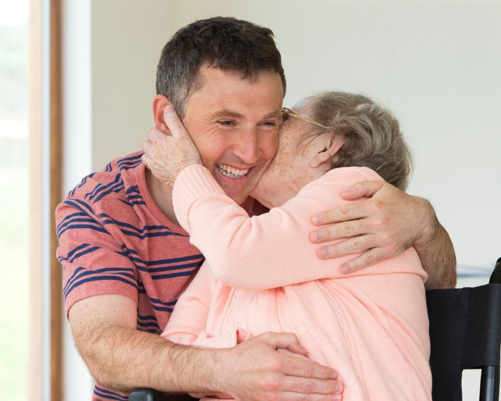 Man giving his grandmother a big hug and smiling
